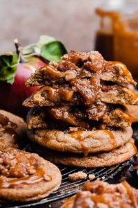 Apple Pie Cookies taste like apple pie in cookie form! An apple pie spiced cookie is filled with a tender apple filling and topped with a brown sugar crumble and finished with a drizzle of luscious salted caramel sauce. These cookies are the perfect fall treat - and taste just like mini apple pies!