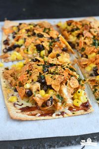 Chicken Taco Pizza {A 20 minute meal} - Tacos and Pizza are both popular meals with kids so you know this is going to be a hit! It's a great way to use up leftover grilled, or shredded chicken! #pizzanight #tacotuesday #chickentacos #chickenrecipes #chicken #tacos #doritos #pizza #pizzarecipe #flatbreadpizza #leftoverchicken #quickmeals #easymeals #weeknightdinner