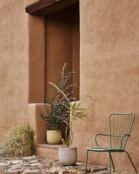 Inspired by vintage dolly tubs, these ridged planters are hand-crafted from lightweight fiber concrete. This frost-resistant material allows the planters to be stored outside over the winter when emptied and placed upside down. | Fiber Concrete Barrel Pot, 7" in Yellow at Terrain