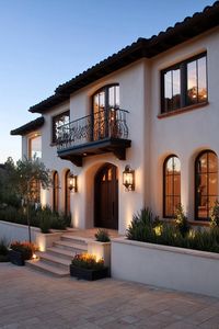 Modern Californian house mediterranean style facade with wicker lighting fixtures. Check out all of these striking exterior Californian Mediterranean-style homes, mixing classic charm with modern elegance for a picturesque look.