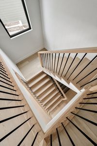 Captivating stair railing with a combination of natural wood and black metal spindles.