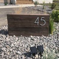 Are you tired of the same old address sign ideas? It's time to shake things up! Dive into our collection of 7 incredible address sign ideas that aren't 'on the house' but instead, blend into your beautiful front yard landscaping. From chic, modern house numbers to creative placement options, we've got you covered! Get ready to wow your neighbors and make your home truly stand out. Get your numbers today!