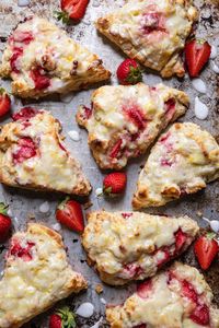 These Strawberry Cream Cheese Scones are no ordinary scone recipe. They are light and fluffy, not dry and not too sweet with surprise bits of real strawberries and cream cheese that are reminiscent of cheesecake. Pre-freezing the cubes of cream cheese and strawberries help make these scones just a little bit easier especially if you are using extra ripe summer strawberries.