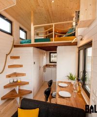 The bedroom loft has a rope railing and built-in dresser.