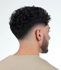 A low drop fade: gently curves around the ears and neckline, providing a subtle and sophisticated look. It’s a refined choice that complements various hair lengths and textures.