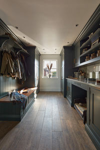 Discover a unique blend of style and functionality with our 'Avocado' dark green boot room and utility design. This thoughtfully designed space caters to all your needs - from laundry to pet necessities, offering a harmonious blend of order and elegance. Every item has its place, transforming the mundane into a beautiful, practical experience.