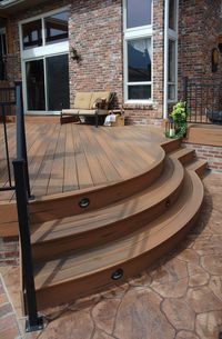 Patio with curved stairs. This is Fiberon composite decking. It's low maintenance, eco-friendly and beautiful. Why use wood when composites are so much better!