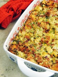 Bacon, Leek, and Artichoke Bread Pudding in a white casserole dish.