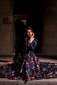 NEELA Floral Sequin Skirt by HARLEEN KAUR. Floral embroidered high waisted lehenga skirt with black lining. Embroidery contains red, white, and navy floral sequin motifs. Style this lehenga skirt with a black crop top for a fun reception look during a south asian wedding weekend!