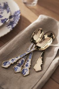 Discover the entire Abi Dinnerware Collection by AnthroLiving. Inspired by traditional Dutch Delftware and French toile fabrics, these dainty stainless steel spoons feature handpainted prints of florals and bees set atop a modern-yet-vintage shape. | Abi Teaspoons, Set of 4 by Anthropologie in Blue, Size: Small