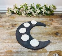 These stunning and contemporary handmade concrete Ramadan Crescent Moon tea light holders. The holder is 20cm High / 18cm Width.   These are made with stone and can be used as a trinket dish, tea light holder or for shot glasses.  Each tealight holder is going to have its own unique design, photos are for guidance. Due to the natural setting of concrete some items may have air bubbles when moulded. It's these minor [im]perfections which make each item totally bespoke.  These trays can be wiped d