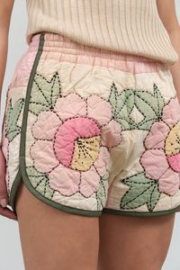 One of a kind quilt short from Carleen handcrafted from vintage quilts. Featuring a soft cotton binding, a convenient back pocket, and an elastic waistband. Each piece is completely different in color and quilt design.