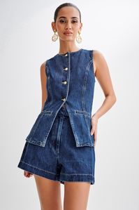 Hands down staple. Presenting the ABEL Denim Button Up Top, a modern essential for your wardrobe rotation. Boasting a round neckline and a convenient centre front button closure, this sleeveless top offers a versatile and chic aesthetic. The addition of front mock pockets adds a hint of utilitarian flair, while princess seams ensure a flattering silhouette. This longline vest is perfect for layering over various outfits, whether you're going for a relaxed weekend look with the Abel Denim Shorts