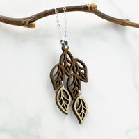 "This necklace features an organic, intricately cut cascade of leaves in two tones of wood - walnut and maple. It is a bold, yet feminine, boho modern style. Wood and silver necklaces can be dressed up or down, making them the perfect complement to any outfit! Pair with the matching leaves earrings for a coordinated look: https://www.etsy.com/listing/782167000/leaves-wood-and-silver-dangle-earrings?ref=shop_home_active_16&frs=1 All pieces are expertly handcrafted with keen attention to quali