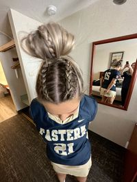 Two small middle dutch braids into messy top bun!