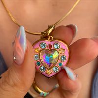 Description:Filled Enamel Heart Locket NecklaceSpecifications:Material: colorful cubic zirconia, copper, enamel, 18k goldColors: goldSize: 40 cm + 5 cm extWeight: 8 g/pcs Add some color and love to your outfit with our Filled Enamel Heart Locket Necklace! 🌈❤️ Keep your secrets close with this charming locket. Perfect for any special occasion or just for fun. (Bonus points for cuteness overload!)