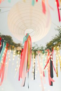 here's what i'm picturing... lanterns with tissue tassel fringe or ribbons