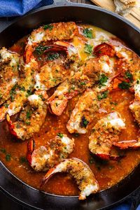 Ready in 30 minutes, this outrageously delicious Broiled Lobster Oreganata combines succulent lobster tails stuffed with seasoned breadcrumbs and broiled in a garlicky white wine tomato sauce. Be sure to serve with crusty bread or pasta because wasting the sauce would be a crime! Perfect for Christmas Eve's Feast of the Seven Fishes! #seafood #lobster #feastofthesevenfishes