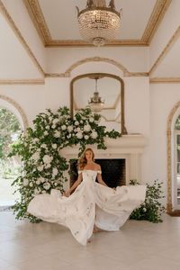 This twirl-worthy A-line wedding dress is made with luxurious Jacquard fabric and is hand painted with green florals. Try on this Savin London gown at Laura & Leigh Bridal!