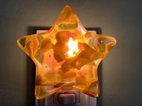 "This night light is a perfect a perfect little star to light the dark nights. This piece was cast fused using a mold. It is made using assorted small cut pieces of glass and full fused. This night light was handcrafted by myself in my workshop. It measures approximately 4\". Your new night light will come ready to plug in with your choice of base color and style with a 5 watt clear bulb. MANUAL BASE: ON/OFF TOGGLE SWITCH SENSOR BASE: This base goes on automatically when it gets dark. *If you pl