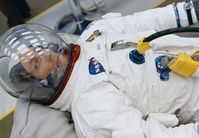 While seemingly resting, astronaut Jack Swigert, command module pilot for the Apollo 13 mission, prepares for the ensuing launch in the suiting room at NASA's Kennedy Space Center. Swigert replaced astronaut Ken Mattingly on the Apollo 13 crew when it was discovered that Mattingly had been exposed to the measles. (Mattingly later flew on the Apollo 16 mission instead.)