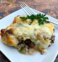 Keto Low-Carb Philly Cheese Steak Casserole is a quick and easy steak dinner recipe with sirloin steak, cream cheese, green bell peppers, and mushrooms. This is the best steak marinade recipe and you can also use flank steak if you wish. If you are looking for sides to pair with your steak, going the casserole route is perfect! Everything in one meal prep friendly dish. #KetoRecipes #KetoSteak