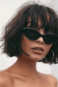 This French bob falls to chin-length with tousled, layered pieces that create natural volume and movement throughout. Full, feathered bangs sit across the forehead, while the textured cut frames the face with a casual, French-inspired look. - Click to see more of 35 Effortlessly Elegant French Bob Cuts That Define Chic Parisian Style and follow us for more hairstyle ideas. // Photo Credit: Instagram @barbaragomesrr