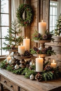 Tiered stand with freh greenery, pinecones and a candle for a warm glow.