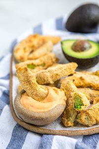 These Baked Avocado Fries are oven-baked and oil-free, but still crispy and tasty! Vegan, Gluten-Free, and only 7 ingredients. #avocadofries #vegan #plantbased #glutenfree #avocado #avocadorecipes #avocadotacos #oilfree via frommybowl.com