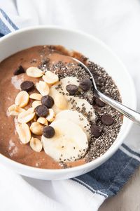 This Chocolate Peanut Butter Smoothie Bowl tastes like a treat, but is so healthy! Frozen bananas are mixed with a little almond milk, peanut butter, cocoa powder, dates for sweetness, and chia seeds for thickness.