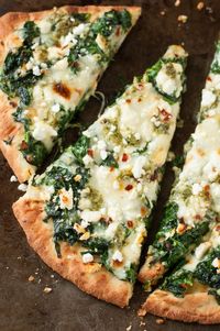 Aiming to eat more veggies? This Three Cheese Pesto Spinach Flatbread Pizza packs an entire box of spinach into one gloriously cheesy single-serving pizza!