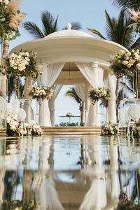 Exchange vows amidst the stunning beauty of Cabo San Lucas at Hyatt Ziva Los Cabos' oceanfront wedding gazebo. This elegant setting with white drapery and lush floral arrangements provides the perfect backdrop for your special day.   #HyattZivaLosCabos #pinterestworthy #travel #tropicalvacation #vacation #loscabos #mexico #paradise #allinclusive #pinterestwedding #aesthetic #fashion #inspiration  #travelphotography #mexicowedding