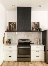 When I first came up with the design for our kitchen, I envisioned a black range hood chimney...which we installed originally. What I hadn't taken account for was our 10 foot ceilings and the issue of the chimney being too short to reach to the ceiling. We were left with the options of purchasing an extension which would run around $200 for a three sided metal piece, or to leave it as is - looking a little funny, or to build a vent hood and just cover it all up.You can guess what my vo…