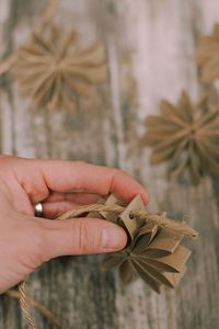 Learn how to make a beautiful rustic chic garland with this simple tutorial, showing you how to make a DIY toilet paper tube flower garland, using old recycled toilet paper rolls!