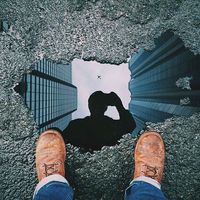 I chose this photo because the photographer was very creative in choosing a small puddle to reflect his surroundings