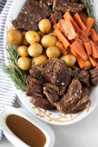 Instant Pot or Slow Cooker Beef Pot Roast, Carrots, and Potatoes makes the most tender pot roast with lots of flavor. Using a pressure cooker or slow cooker makes this one pot meal so easy to make. This recipe makes enough for 4 servings or increase the amount of beef to make up to 8 servings. You’ll love this recipe! Almost every Sunday when I was young, my mom would have a beef pot roast cooking while we went to church. I remember walking in the door after church and smelling the d…