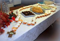 This is similar to how we set up the cupcake rosary when it was our turn to host the monthly after-Mass social. The kids LOVED the cupcake rosary, and posed for photos with it. Highly recommended for any parish gatherings or for any home celebrations of the sacraments, especially with children present.