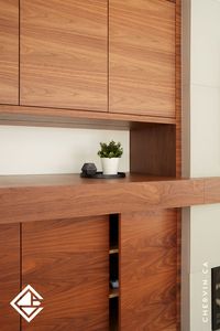 Elevate your family room with a mid-century modern touch using console cabinetry crafted from natural walnut. The frameless flat panel, push-to-open design imparts a seamless and crisply modern appearance, while the flat-cut walnut adds a rich and warm aesthetic to this custom family room console... #LivingRoomDesign #LivingRoomConsole #CustomCabinetry #CabinetDesign