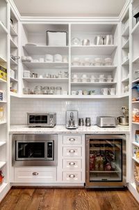 Wow. What a walk-in pantry. I like the notion of putting a drink fridge in the pantry, and the counter-top toaster to keep it out of the main kitchen area, but this seems to take mucho square footage. by malinda