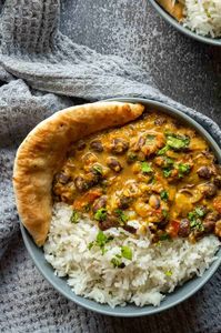 This easy creamy black bean curry needs to be added to your favorite recipes! With lots of Indian-inspired spices and coconut cream (use the cream from a tin of chilled coconut milk if you can't get coconut cream), it's vegan and delicious, as well as easy to add extra vegetables as well. Some spinach, potato, or peppers would go really well. Serve over some fragrant basmati rice with some fresh garlic naan on the side for a sumptuous meal.