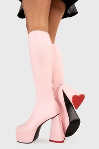 Sweet Talker Platform Knee High Boots in Pink faux leather. These platform boots feature a minimalist look with a heart shaped heel, keeping it nice and classy. Made with eco-friendly materials and 100% cruelty-free, these platform boots are as ethical as they are chic. Vegan PU Leather Wipe Clean