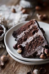 This high altitude chocolate hazelnut cake is made with three layers of moist chocolate cake, filled and frosted with salted chocolate Nutella buttercream and toasted hazelnuts. Top with hazelnuts,or Ferrero Rocher chocolate hazelnut truffles for a simple and delicious holiday cake.