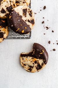 Slice and Bake Chocolate Orange Shortbread Cookies -- a chocolate chunk shortbread cookie recipe flavored with orange zest and dipped in chocolate. SO GOOD. @girlversusdough #girlverusdough #thecookies #chocolatechipcookie