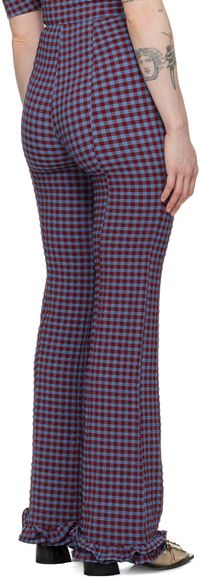 Find GANNI Blue & Red Check Trousers on Editorialist. Stretch recycled polyester-blend seersucker trousers. Check pattern throughout. · Ruffled trim at cuffs · Concealed zip closure at side Supplier color: Racing red