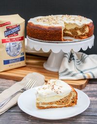 Carrot Cake Swirl Cheesecake is the best of both worlds. Perfectly spiced cake paired with a creamy vanilla cheesecake, and topped with a rich cream cheese topping. #sponsored #springsweetsweek #carrotcake #cheesecake