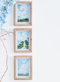 Our Blue Skies Landscape Framed Print, Set of 3, will be a beautiful addition to your home. Featuring three different landscapes in vibrant colors, each framed in slightly whitewashed wood, this wall decor set has an ardent feel that will work perfectly for any modern farmhouse design plan. Hang this gorgeous eye-catching print trio in any room to bring serene elegance.