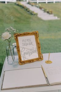 Gold, ornate mirror with white hand-lettered calligraphy