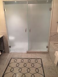 Frosted glass shower and toilet door saving space and adding light. Great standard and Mosaic tile design combination.