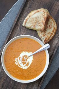 Now that we're entering the colder season, making some of this homemade tomato soup and grilled cheese is the perfect way to warm up! This soup has a delicious combination of roasted tomatoes and garlic, sauteed onions, and fresh basil--along with more seasonings that complement and deepen the other flavors. Plus, a sourdough grilled cheese sandwich with cheddar and smoked gouda for dunking makes this the ideal comfort food!  #comfortfoodrecipe #tomatosouprecipe #tomatobasilsoup #grilledcheeserecipes #winterrecipeideas #easydinnerrecipes #easysoups