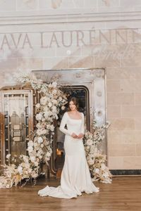 This timeless long sleeve wedding gown from Ava Laurenne Bride exudes modern elegance with its sleek silhouette, square neckline, and fitted bodice. Perfect for the bride seeking a sophisticated yet minimalist look, this wedding dress blends classic charm with contemporary refinement. Book your bridal appointment today to find your dream bridal gown! @arliquinn